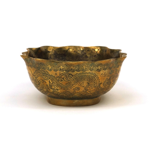 558 - Chinese bronze bowl with shaped edge, engraved with dragons chasing the flaming pearl, character mar... 