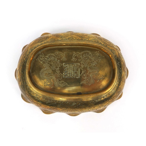 558 - Chinese bronze bowl with shaped edge, engraved with dragons chasing the flaming pearl, character mar... 