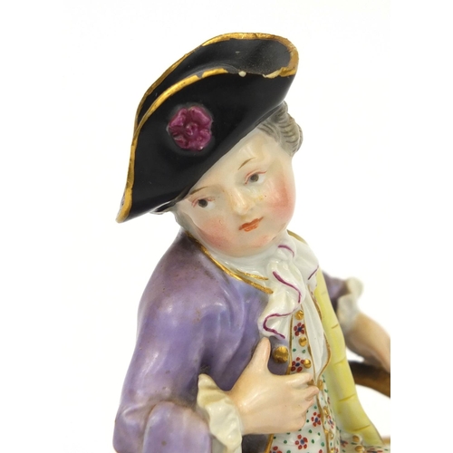 666 - Meissen hand painted porcelain double salt, in the form of a young man sat on two baskets, cross swo... 