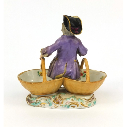 666 - Meissen hand painted porcelain double salt, in the form of a young man sat on two baskets, cross swo... 