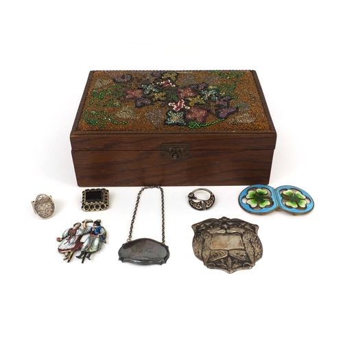 152 - Objects including a silver port decanter label, enamelled stand of two figures, impressed marks to t... 