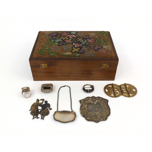 152 - Objects including a silver port decanter label, enamelled stand of two figures, impressed marks to t... 