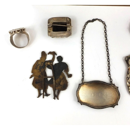 152 - Objects including a silver port decanter label, enamelled stand of two figures, impressed marks to t... 