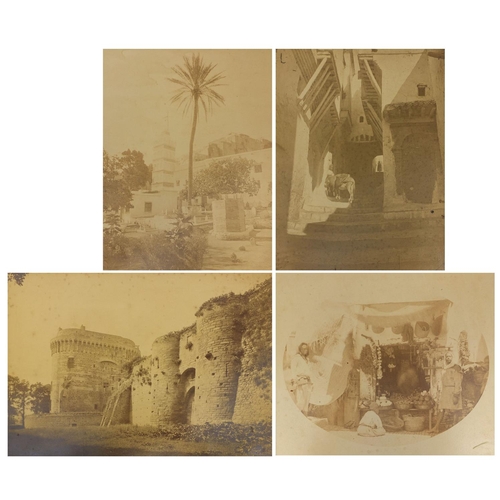 193 - Four Middle Eastern black and white photographs, one of a figure on a stairway, another with figures... 