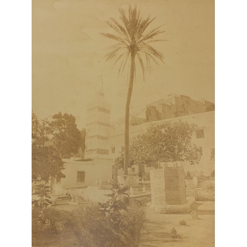 193 - Four Middle Eastern black and white photographs, one of a figure on a stairway, another with figures... 