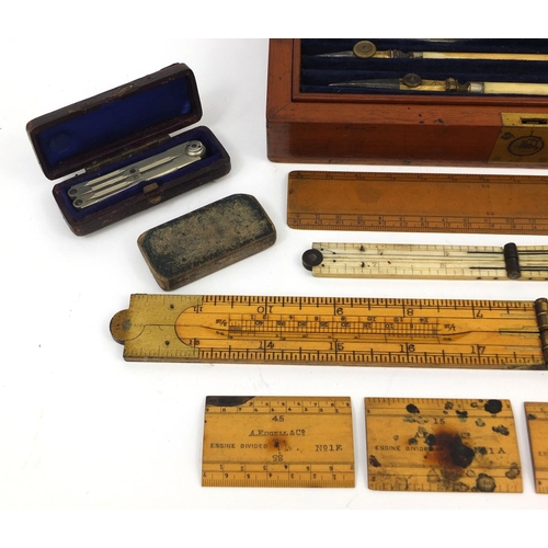 64 - Drawing instruments including a folding ivory ruler and a J Hicks of London war department mahogany ... 