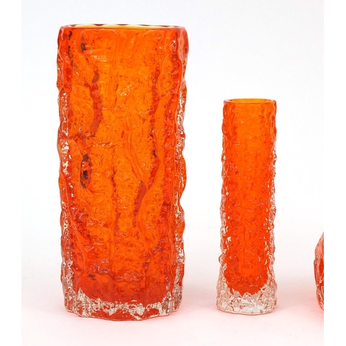 742 - Four Whitefriars tangerine textured glass vases, comprising two cylindrical examples and one of mall... 