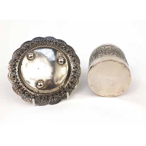 602 - Indian unmarked silver cylindrical box and cover, together with a pin dish, both embossed with flowe... 