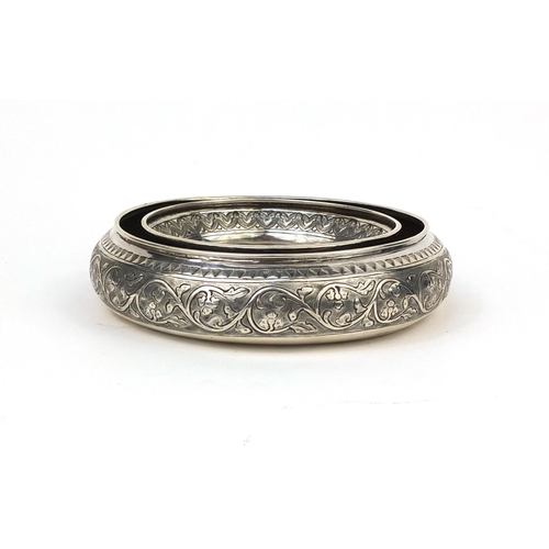 603 - Circular Middle Eastern unmarked silver holder embossed with floral motifs, 16.5cm in diameter, appr... 