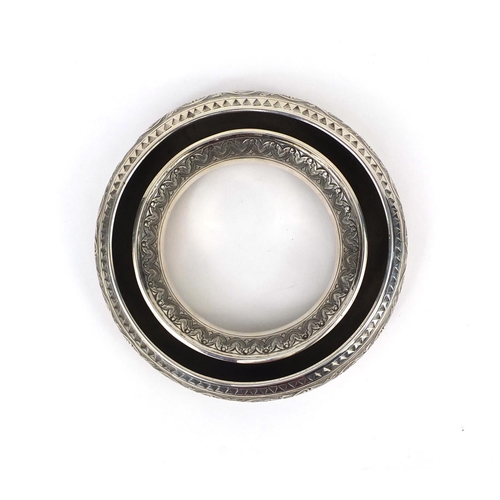 603 - Circular Middle Eastern unmarked silver holder embossed with floral motifs, 16.5cm in diameter, appr... 