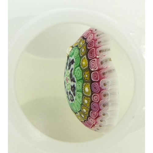 733 - White overlaid glass paperweight with colourful canes, together with a white overlaid pot with silve... 