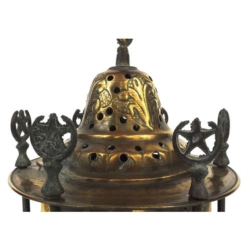 639 - Islamic brass hanging lamp with coloured glass panels, engraved with floral motifs, 23cm high