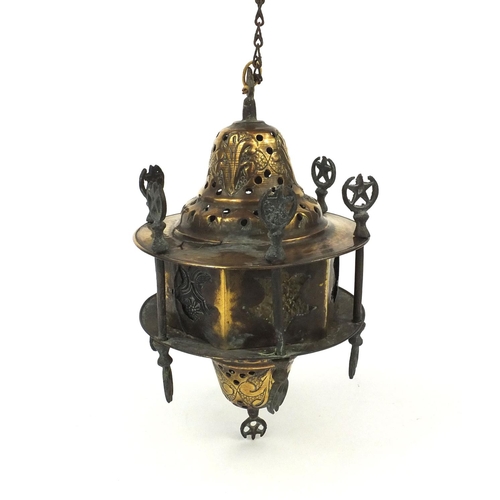 639 - Islamic brass hanging lamp with coloured glass panels, engraved with floral motifs, 23cm high