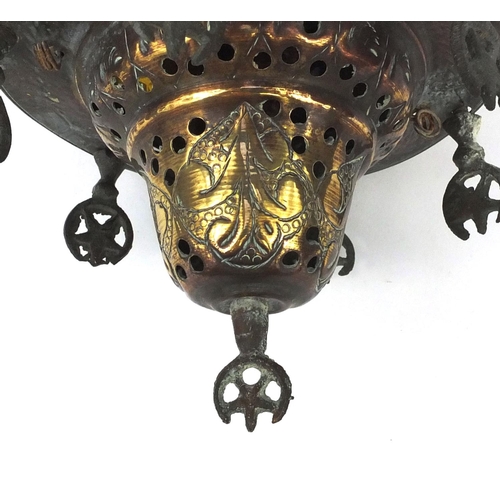 639 - Islamic brass hanging lamp with coloured glass panels, engraved with floral motifs, 23cm high