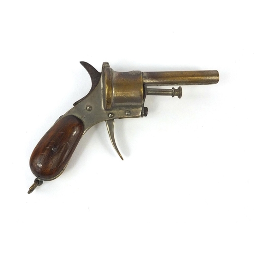 110 - Novelty cigar cutter in the form of a pistol, with wooden grip, 9cm wide