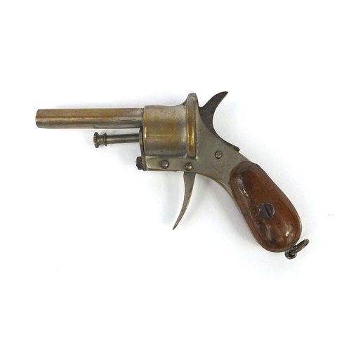 110 - Novelty cigar cutter in the form of a pistol, with wooden grip, 9cm wide