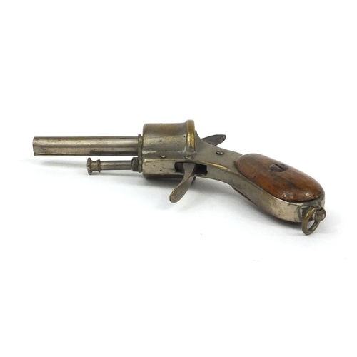 110 - Novelty cigar cutter in the form of a pistol, with wooden grip, 9cm wide