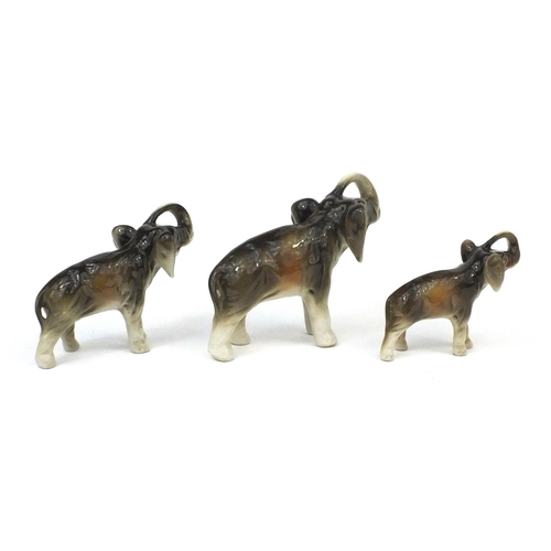 2139 - Graduated set of three Royal Dux elephants, each with original paper labels, the largest 14cm in len... 