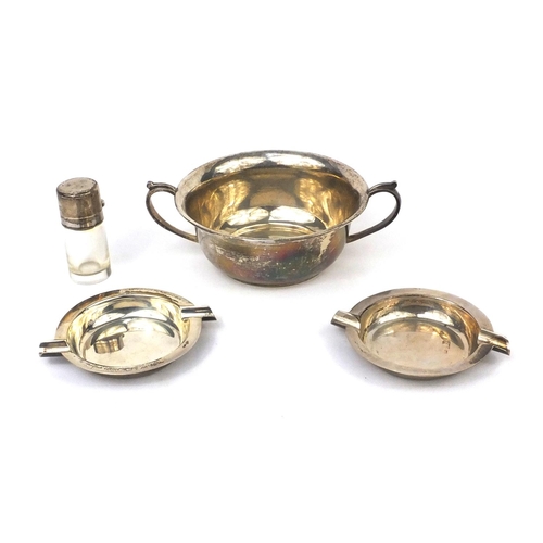 2420 - Silver items comprising twin handled bowl, two circular ashtrays and a glass scent bottle, various h... 