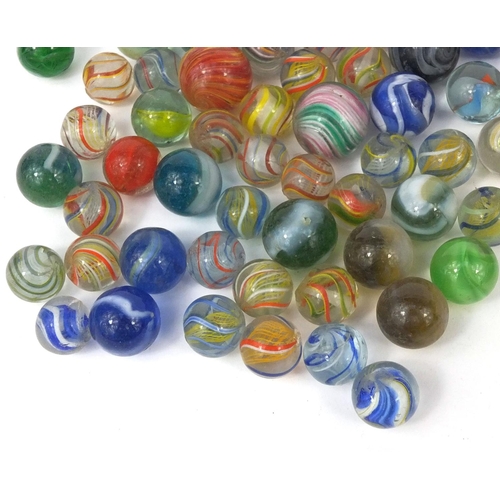 426 - Victorian and later glass marbles, with wooden solitaire board, the solitaire board 26cm in diameter