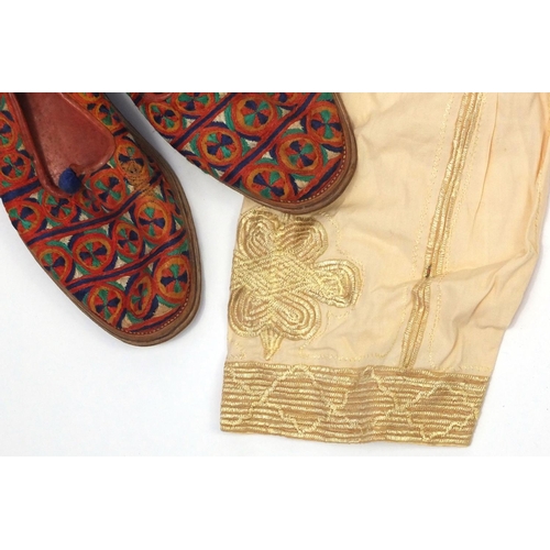 653 - Collection of predominately Nigerian and Ghana traditional clothing and footwear, including embroide... 