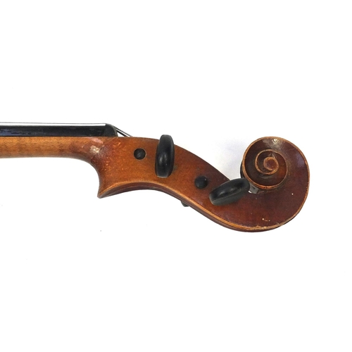 43 - Two old wooden violins, both with scrolled neck and ebonised pegs, the largest 66cm in length