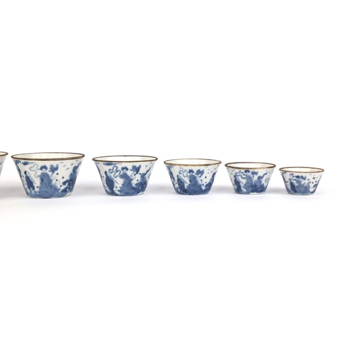 444 - Graduated set of nine Chinese blue and white porcelain bowls, each hand painted with a continuous ba... 