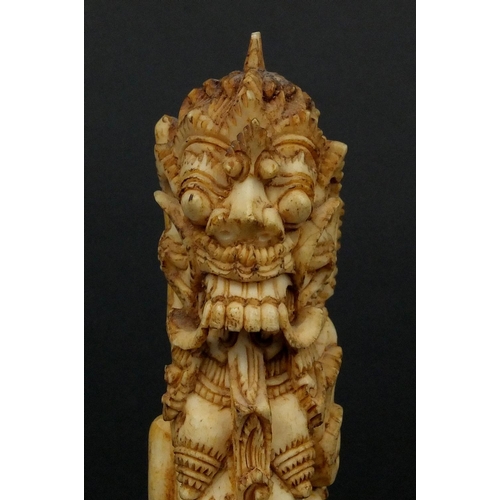 615 - Middle Eastern bone carving of mythical figures, 12cm high