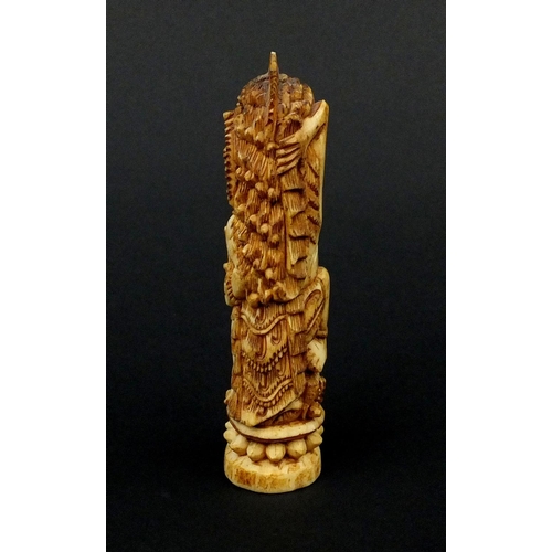 615 - Middle Eastern bone carving of mythical figures, 12cm high