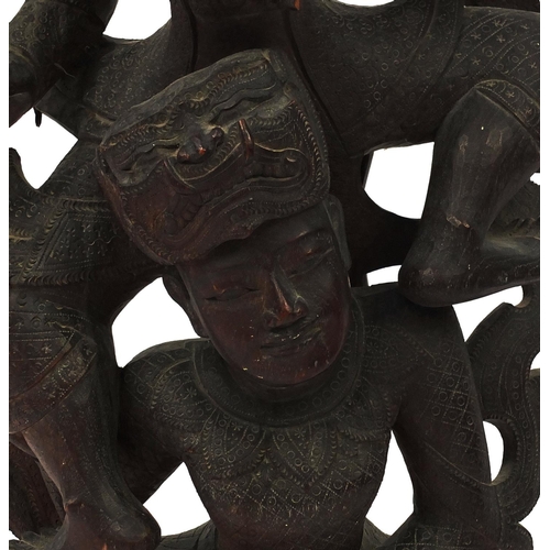 648 - Large Middle Eastern carved wooden figure group of two figures, on a circular base, 77cm high