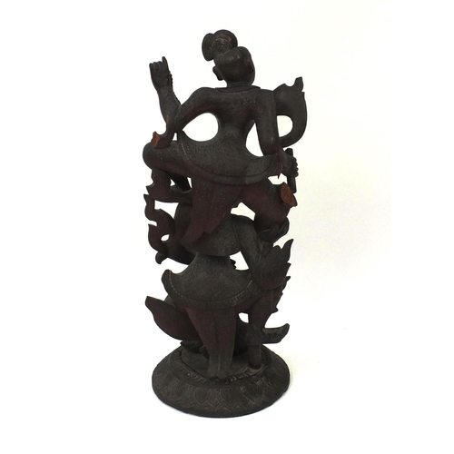 648 - Large Middle Eastern carved wooden figure group of two figures, on a circular base, 77cm high