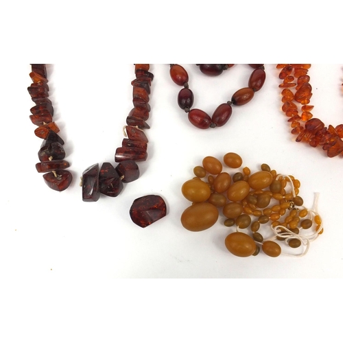 1029 - Selection of amber coloured bead necklaces and loose beads, approximate weight 438.4g