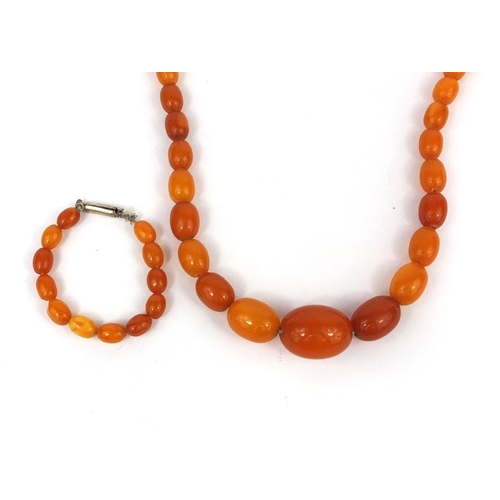 1027 - Butterscotch amber coloured bead necklace and a ring, the necklace 18cm long, approximate weight 15.... 