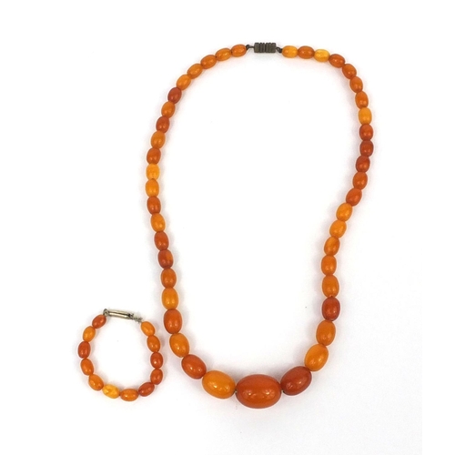 1027 - Butterscotch amber coloured bead necklace and a ring, the necklace 18cm long, approximate weight 15.... 