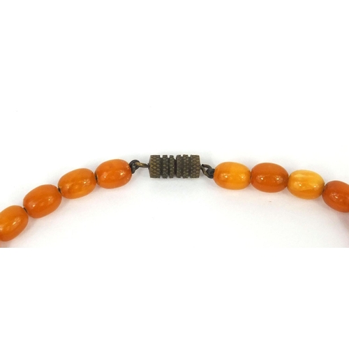 1027 - Butterscotch amber coloured bead necklace and a ring, the necklace 18cm long, approximate weight 15.... 