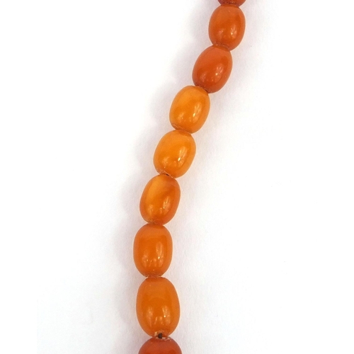 1027 - Butterscotch amber coloured bead necklace and a ring, the necklace 18cm long, approximate weight 15.... 