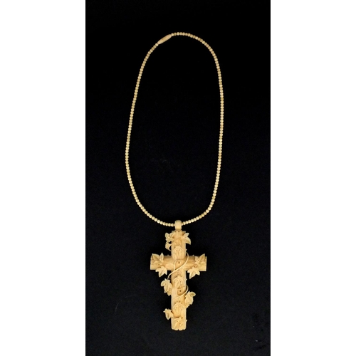 1023 - Victorian ivory cross pendant carved with vines, on a bead necklace, the pendant 9.5cm long, approxi... 