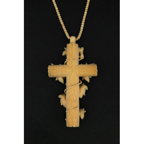 1023 - Victorian ivory cross pendant carved with vines, on a bead necklace, the pendant 9.5cm long, approxi... 