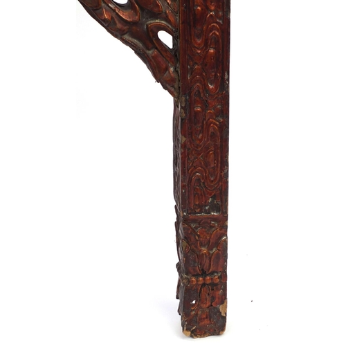 547 - Chinese red lacquered wooden shop hanging, carved with clouse and a dragon, 131cm high