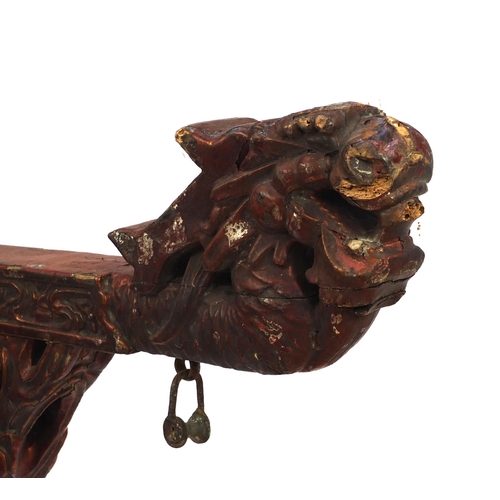 547 - Chinese red lacquered wooden shop hanging, carved with clouse and a dragon, 131cm high