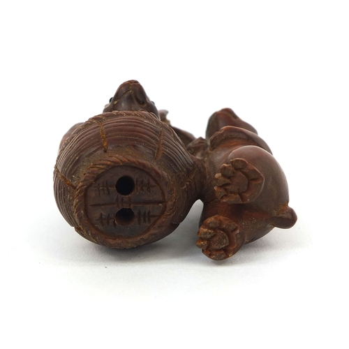 538 - Japanese carved boxwood Netsuke in the form of two rabbits, one in a basket, character to one leg, 5... 