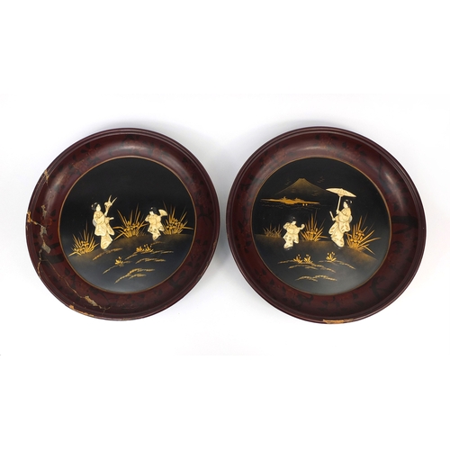 551 - Pair of circular Oriental bone inlaid wall plaques decorated with Geisha girls in an exterior within... 