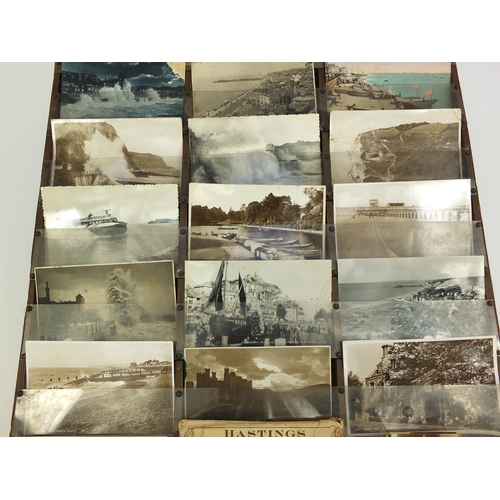 212 - Judges postcard wall display rack containing various local interest postcards including rough sea an... 