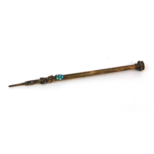 127 - Gilt metal propelling pencil, with turquoise set floral slider and citrine end, length 8.2cm when un... 