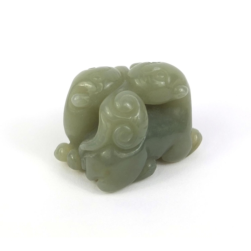 513 - Chinese carved green jade group of two entwined mythical creatures, 3.2cm high