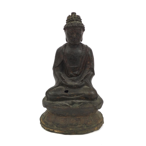 554 - Sino Tibetan bronze Buddha seated in the Lotus position, remnants of gilding and paint, 15cm high