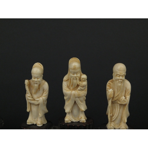 533 - Three Chinese carved ivory figures together with a carved ivory group of three figures below trees, ... 