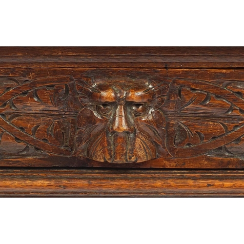 2059 - Victorian oak hall table with tooled leather insert and frieze drawer, carved with grotesque faces a... 