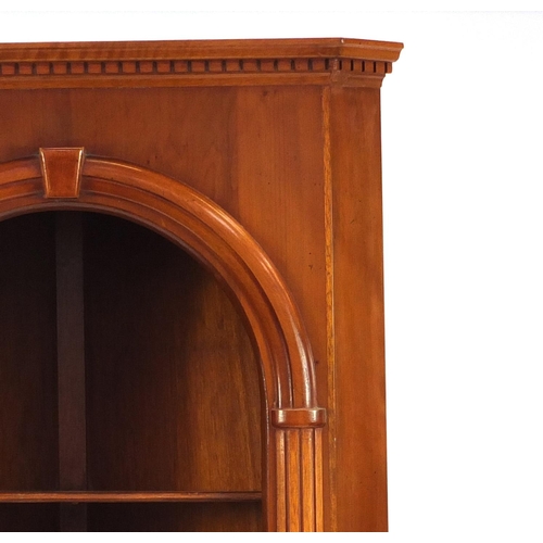2030 - Yew corner cabinet fitted with two open shelves above a cupboard door, raised on bracket feet, 179cm... 