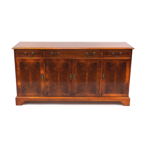 2029 - Inlaid yew sideboard fitted with three drawers above four cupboard doors raised on bracket feet, 80c... 